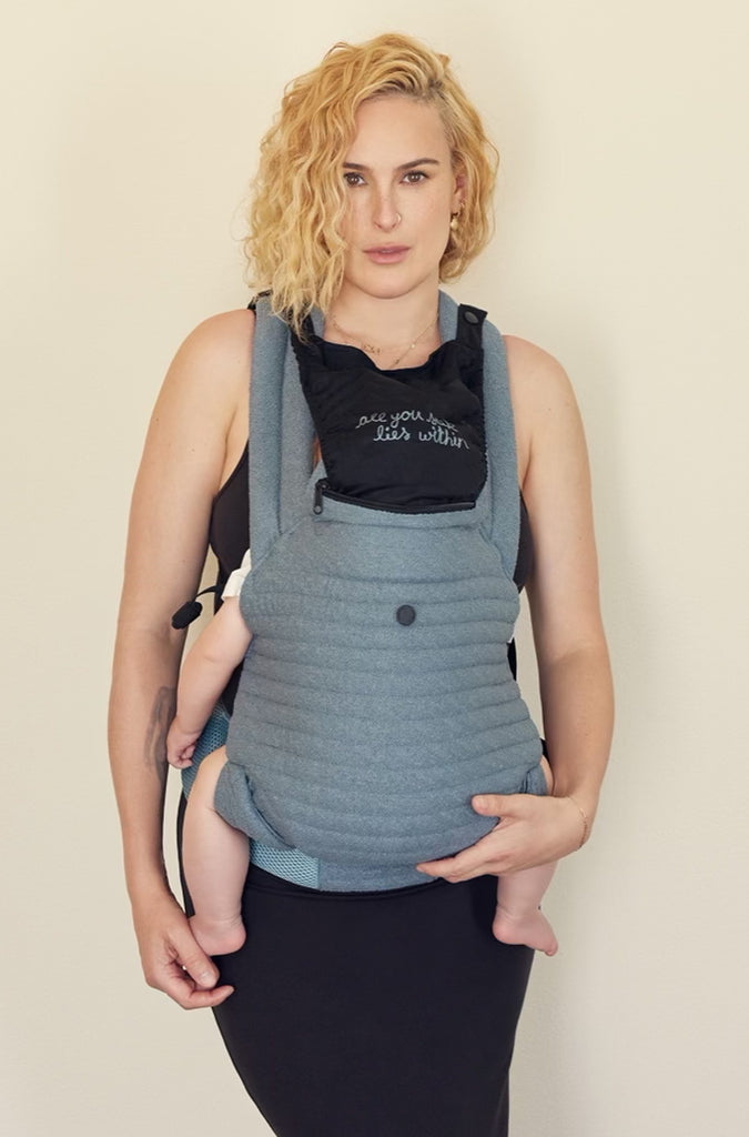 The Armadillo Baby Carrier in Lou Blue worn by Rumer Willis
